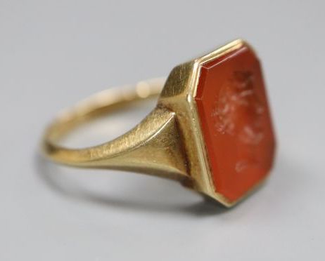 A continental yellow metal and intaglio carnelian set signet ring, carved with head of a lady to sinister, size N/O, gross 4.1 grams